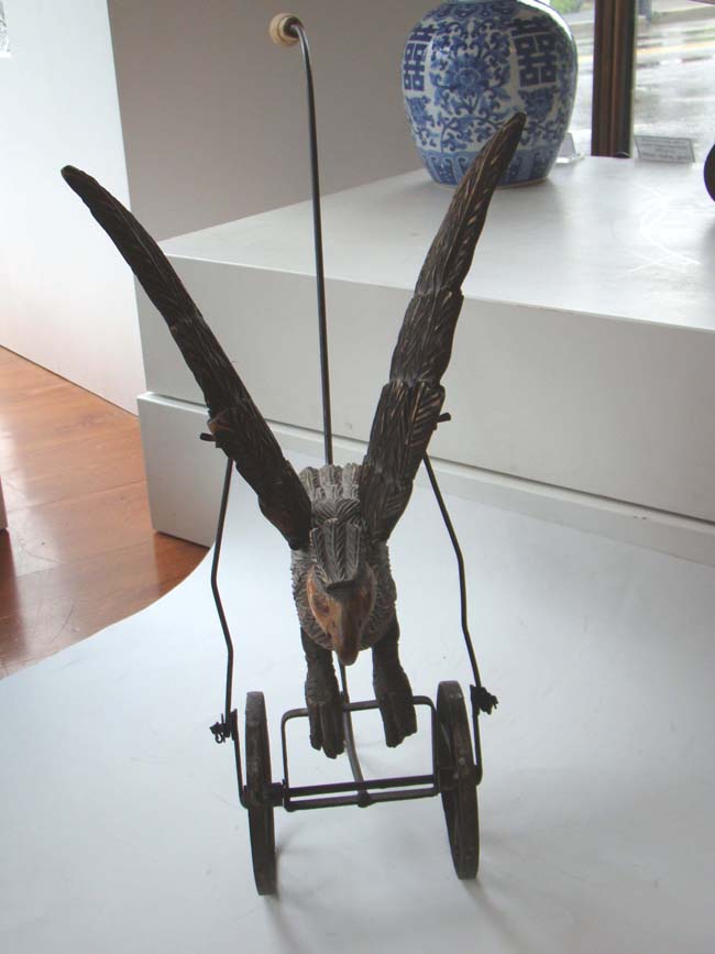 A late Victorian carved wooden spread wing eagle push toy — image 4